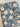 Floral patterned fabric with white flowers on a blue background