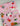 Pink fabric with cartoon cat designs on a white background