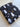 Black fabric with white ghost and flower pattern on a wooden floor