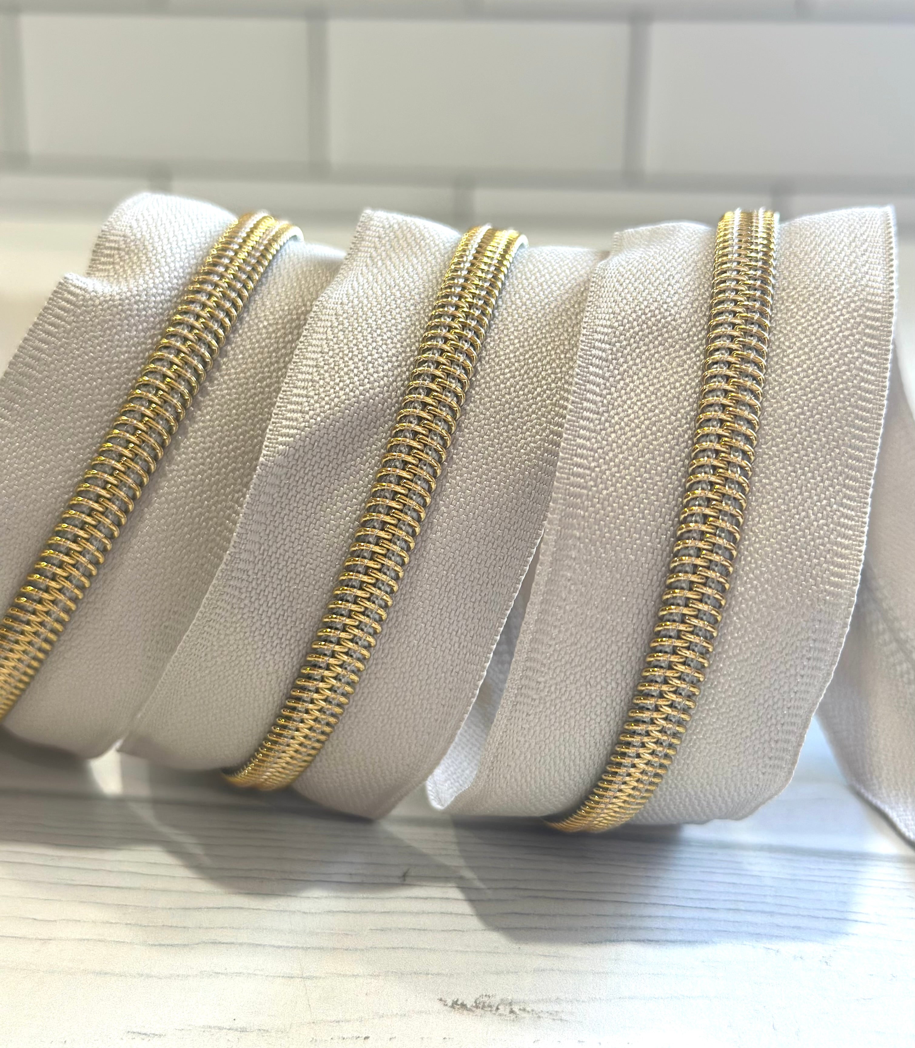 Greige with Gold Teeth Zipper Tape