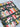 Patterned fabric with books and flowers on a dark background