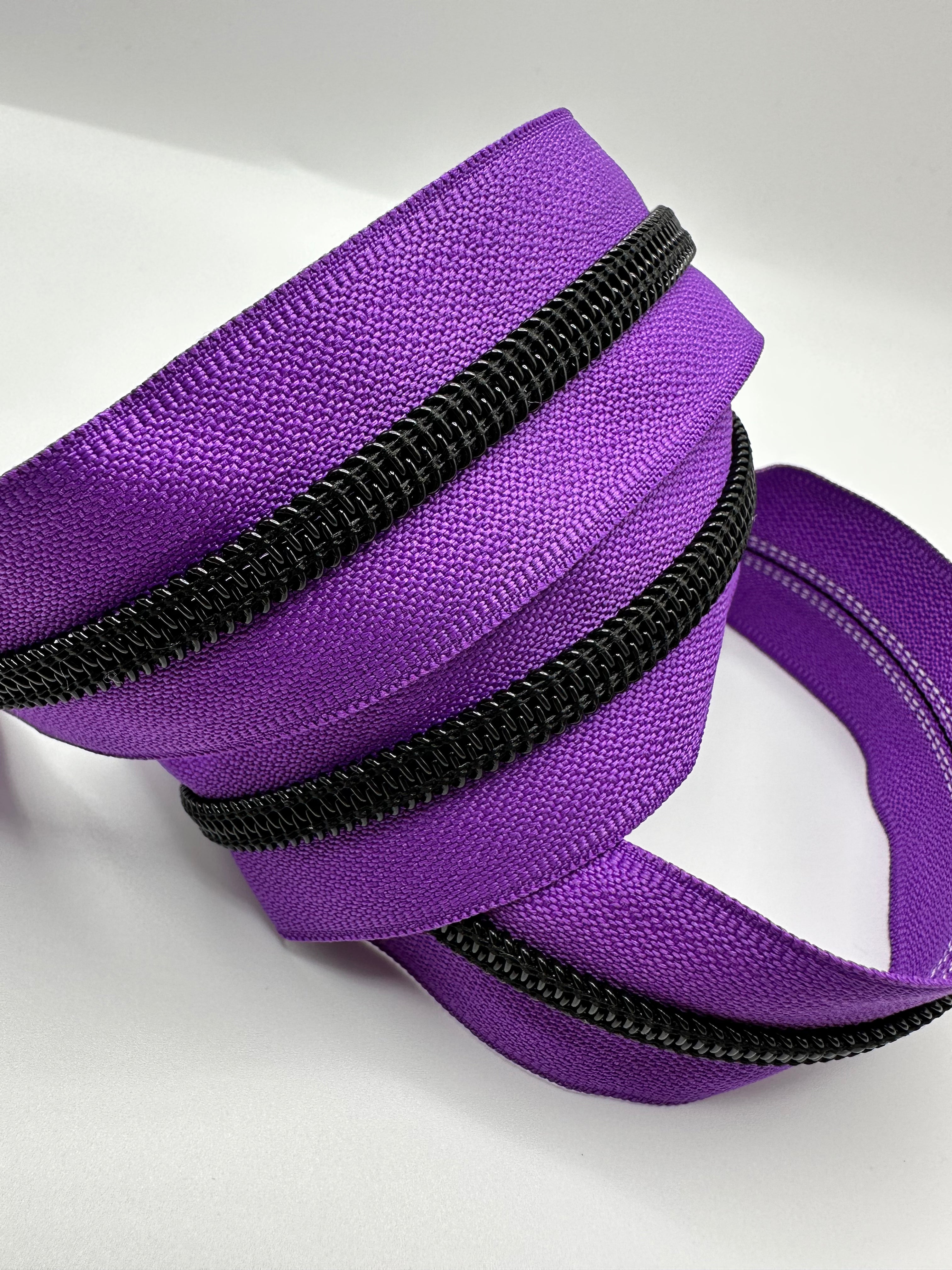 Black teeth on purple zipper tape