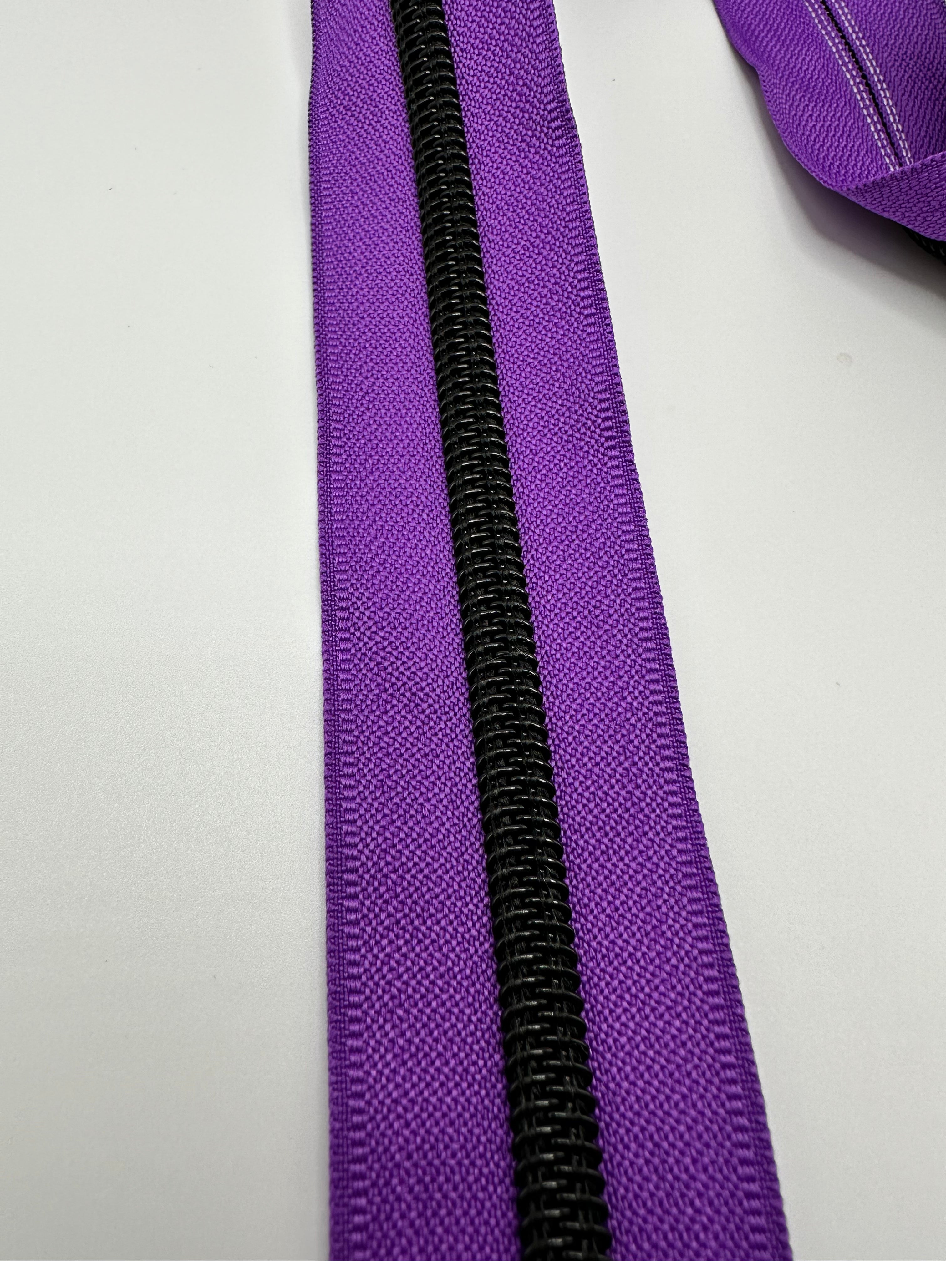 Black teeth on purple zipper tape