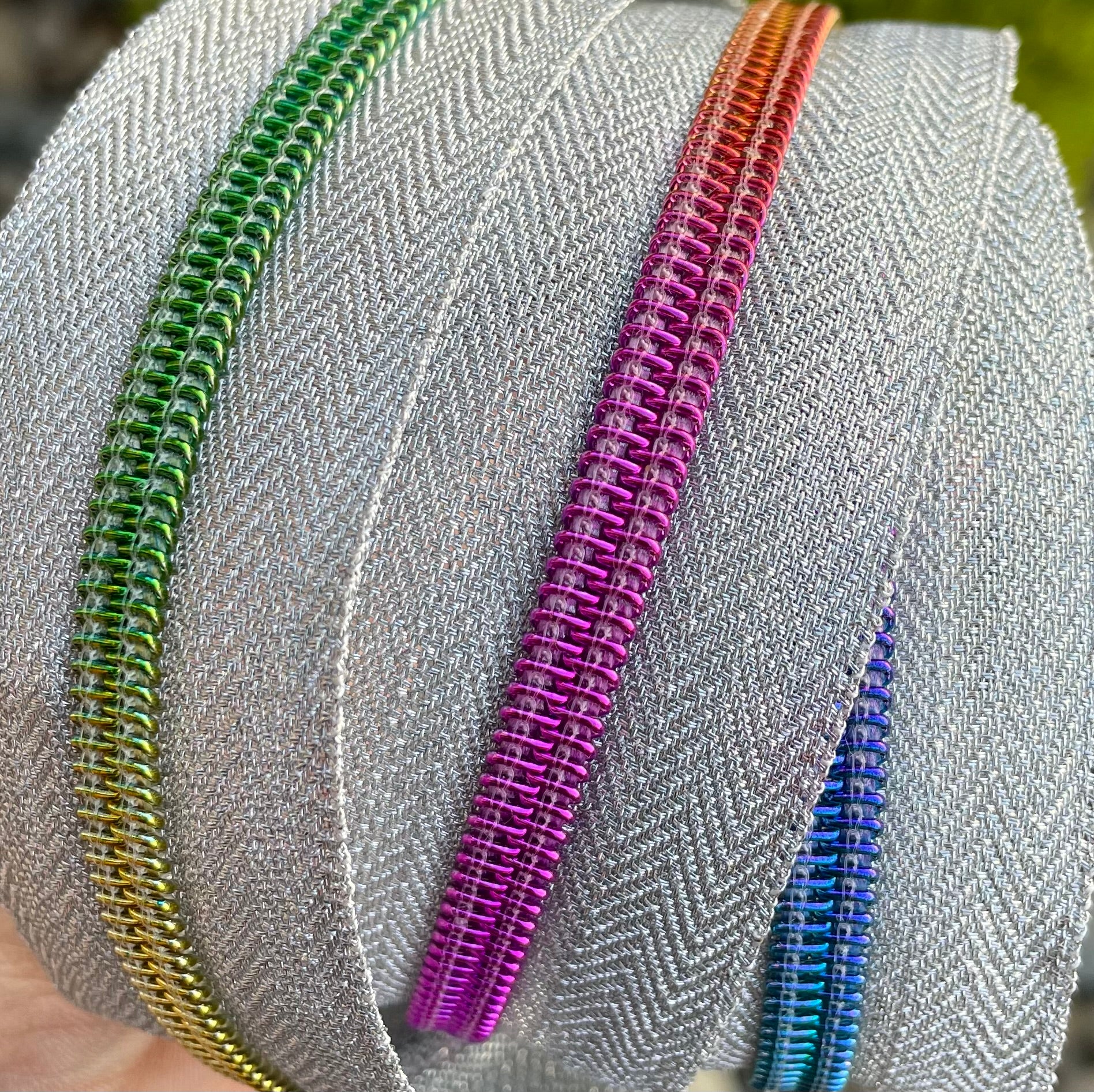 Metallic silver with rainbow teeth zipper tape