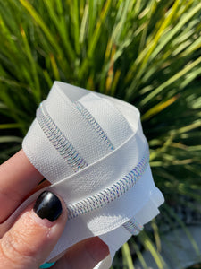 White zipper tape with iridescent teeth